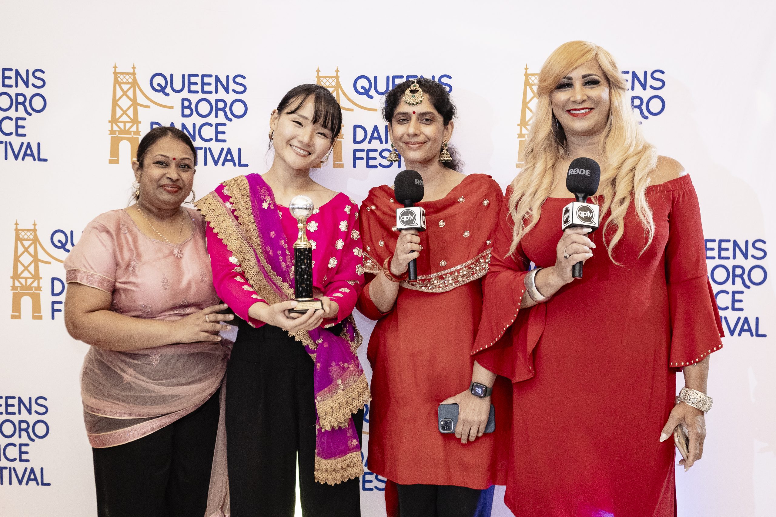 3 dancers, one holding a trophy, with QPTV Roz Nieves at QDF's gala